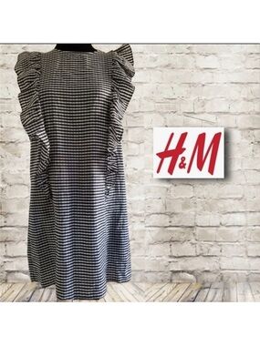 H&M black and white king knee length dress with ruffle sleeves, pockets size 8.